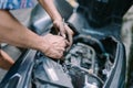 A motorcycle mechanic is checking a damaged engine Royalty Free Stock Photo