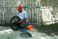 Motorcycle mechanic fixing a motorcycle's tire