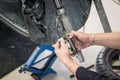 Motorcycle mechanic hands replace brakes in garage.  Worker changing brake disc. Brake disc installation concept Royalty Free Stock Photo