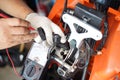 Motorcycle mechanic uses a multimeter voltmeter to check the voltage level in a motorcycle , selective focus