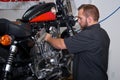 Motorcycle mechanic working on american engine