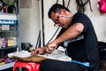 Motorcycle mechanic working in his shop