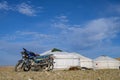 Motorcycle near yurts in Mongolia