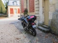 Motorcycle parked in front of Versailles Palace outbuildings, Fr