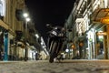 A motorcycle parked in the middle of the street at night