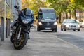 A motorcycle parked on the sidewalk with a defocused city street with cars in the background Royalty Free Stock Photo