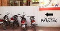 Motorcycle parking, Two Wheeler Parking text in black on a white background wall in India