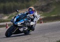 Motorcycle practice leaning into a fast corner on track Royalty Free Stock Photo