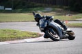 Motorcycle practice leaning into a fast corner on track Royalty Free Stock Photo