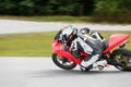 Motorcycle practice leaning into a fast corner on track