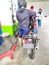 Motorcycle queues that are refueling, at refueling stations