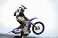 A motorcycle racer in a jump in the air. Side view. Selective focus. Copy space