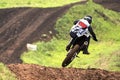 A motorcycle racer loses his balance in a jump from an obstacle. Selective focus
