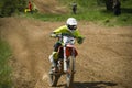 Motorcycle racer overcomes motocross track Royalty Free Stock Photo