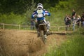 Motorcycle racer overcomes motocross track Royalty Free Stock Photo