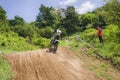 Motorcycle racer overcomes motocross track Royalty Free Stock Photo