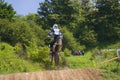 Motorcycle racer overcomes motocross track Royalty Free Stock Photo