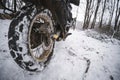 The motorcycle rear wheel is close-up. Rubber and tread are clogged with snow. Concept of transport and travel season. bad weather Royalty Free Stock Photo
