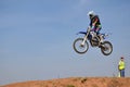 On a motorcycle rider jumps over a high mound of earth Royalty Free Stock Photo