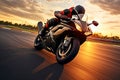 Motorcycle rider rides on a race track at sunset. Motion blur, Motorcycle rider on sport bike rides fast on race track at sunset. Royalty Free Stock Photo