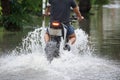 A motorcycle riding through flooded road