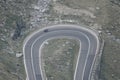 Motorcycle riding on twisted road in the mountains aerial view