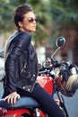 Motorcycle, road trip and woman thinking in city with sunglasses for travel or transport as rebel. Fashion, street and Royalty Free Stock Photo