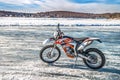 Motorcycle with studded tires on ice is in an open area