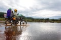 Motorcycle crossing flooded bridge