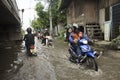 Motorcycle Taxis and volunteer carrying people passed flood on the road go to Bang pai temple