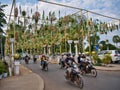 Motorcycle traffic crossing the bridge over the Siem Reap River near the Royal Residence in central Siem Reap, Cambodia