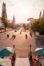 Motorcycle traffic in evening at Da Lat Cathedral with Purple orchid tree