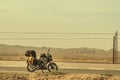 Motorcycle with traveling baggage parked by the roadside in sandstorm weather