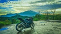 a motorcycle with a view of mountain in the morning Royalty Free Stock Photo