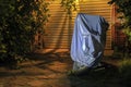 Motorcycle in waterproof sunshade tent  standing by the garage gate in the night. Royalty Free Stock Photo