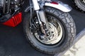 Motorcycle wheels with car accessories in showroom