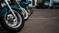 Motorcycle wheels in the parking lot of sport tuned motorcycles standing on the pavement.