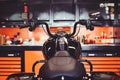 Motorcycles on the floor with workshop tools, a modern garage, storage and repair. This bike will be perfect. repairing a motorcyc Royalty Free Stock Photo