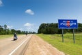 Motorcycles passing by the Mississippi State welcome sign along the US Highway 61