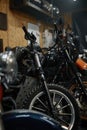 Motorcycles range in garage shop, repaired motorbikes ready for selling