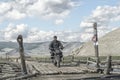 A motorcyclist over a bridge in Mongolian Royalty Free Stock Photo