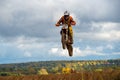 The motorcyclist flies over the forest Royalty Free Stock Photo