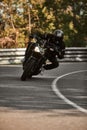 Motorcyclist in full gear cornering on road