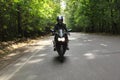 Motorcyclist goes on road, front view Royalty Free Stock Photo