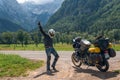 Motorcyclist happy dance with Adventure Motorbike with bags. Motorcycle trip. World Traveling, Lifestyle Travel vacations sport