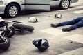 Motorcyclist helmet and motorbike on the street after collision