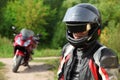 Motorcyclist and his bike on country road Royalty Free Stock Photo