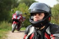 Motorcyclist and his bike on country road Royalty Free Stock Photo