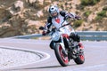 motorcyclist riding on his motorcycle on the road taking a sharp curve Royalty Free Stock Photo