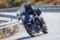 motorcyclist riding on his motorcycle on the road taking a sharp curve Royalty Free Stock Photo